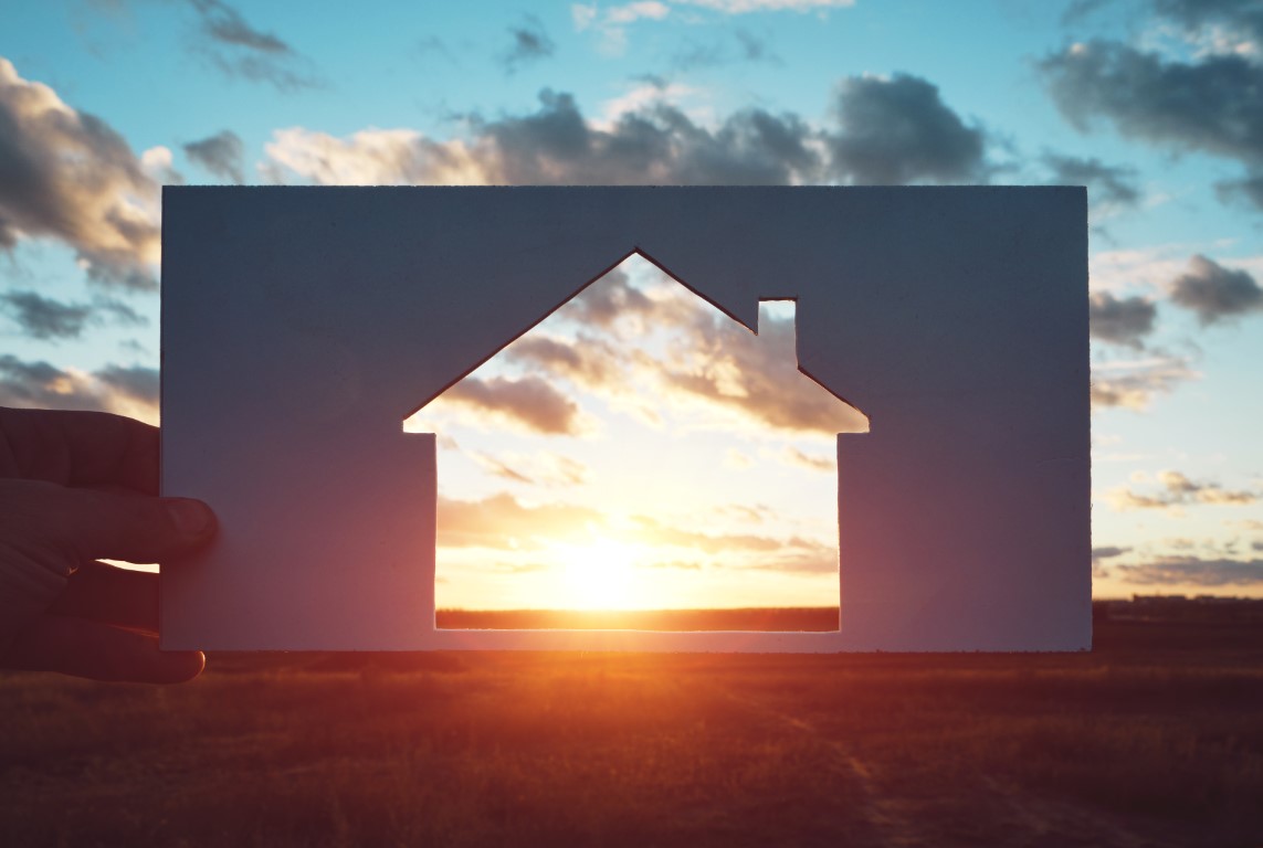 man-holds-piece-paper-with-house-cut-out-it-against-sunset-home-nature-travel-housing-concept.jpg