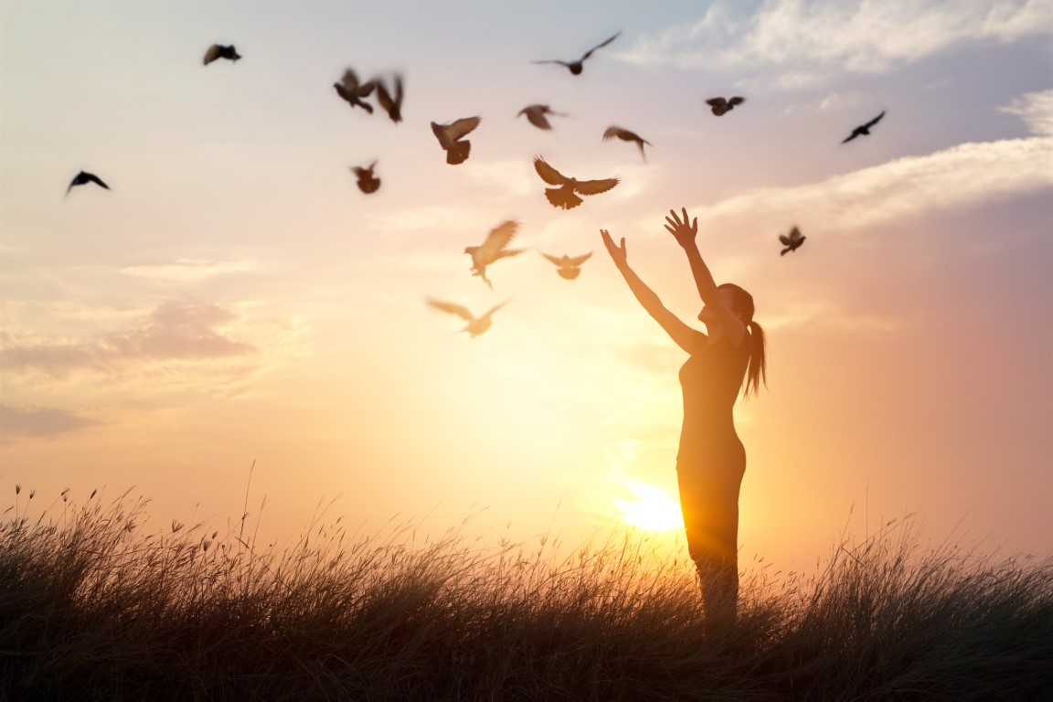 woman-praying-free-birds-nature-sunset-background.jpg